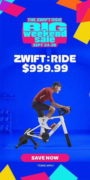 Man rides stationary Zwift bike trainer in advertisement. Text reads The Zwift Ride Big Weekend Sale Sept 24-28. ZWIFT: RIDE $999.99. Colorful shapes and a Save Now button appear below.