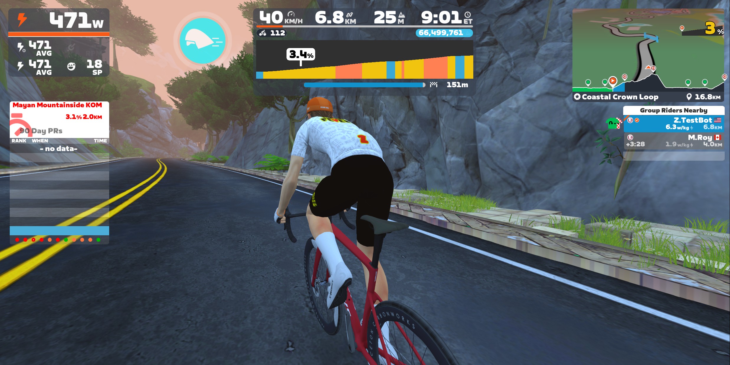A cyclist rides a red road bike along a coastal mountain road in the Zwift virtual cycling app, with performance metrics displayed in a dashboard overlay.