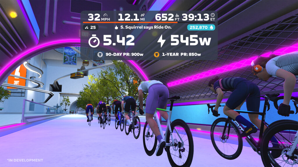 Cyclists ride through a neon-lit tunnel in a virtual cycling game. On-screen stats show speed, distance, climb, elapsed time, current power output, and records, with vibrant purple lighting and outdoor scenery visible.