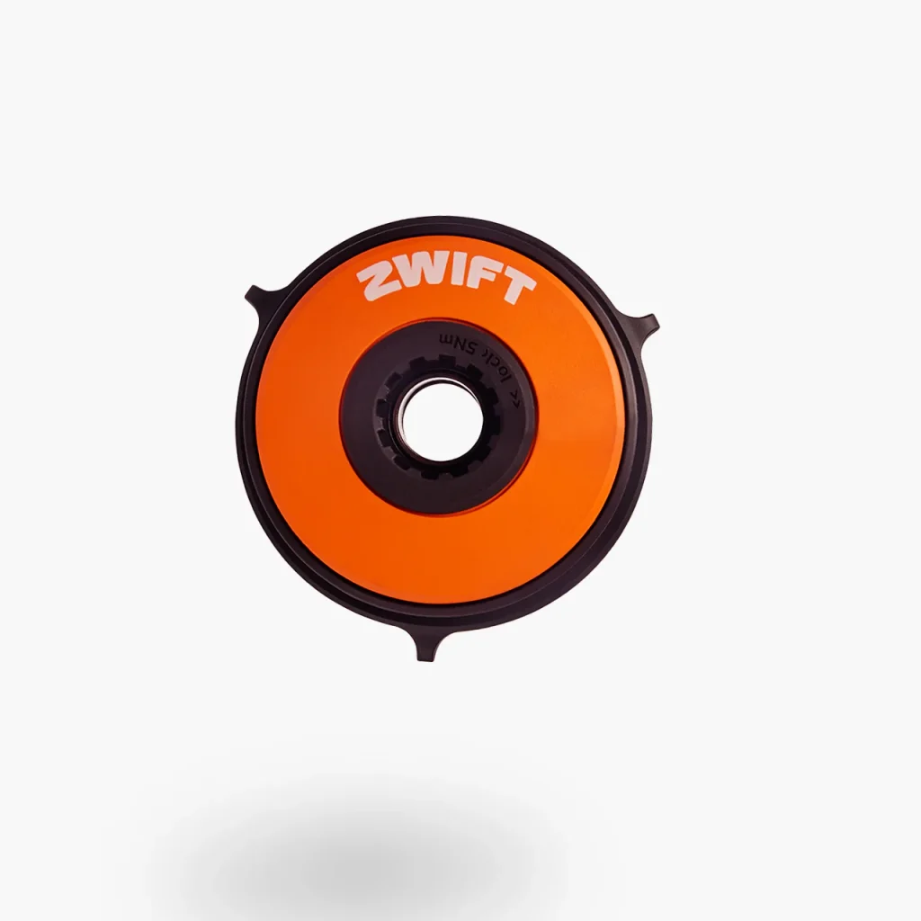 A round, orange Zwift bike trainer cassette tool with a black rim and center, displayed against a plain white background.