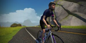 A digital avatar of a cyclist wearing a helmet and blue jersey rides a white road bike along a paved mountain road.