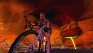 A virtual cyclist rides a white road bike through a cavernous, glowing orange volcanic landscape.