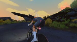 A cyclist in a Zwift kit riding a road bike on a paved path during sunset.