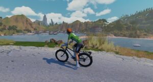 A cyclist wearing a green jersey rides along a coastal path overlooking a bay and distant mountains in a virtual landscape.