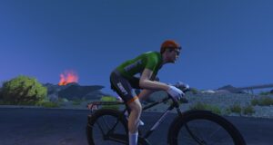 A cyclist in a green and black Zwift jersey rides a black bicycle past a volcanic landscape at night.
