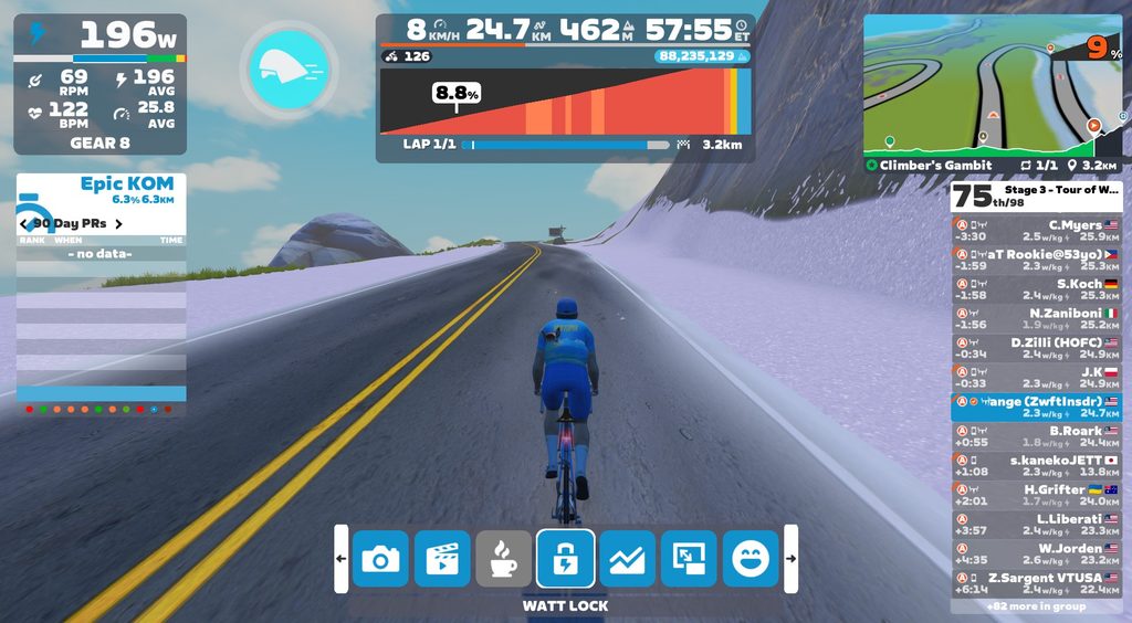 A first-person view of a cyclist on a snowy mountain road in a virtual cycling game, featuring an on-screen dashboard showing power, speed, elevation, and a list of nearby riders.