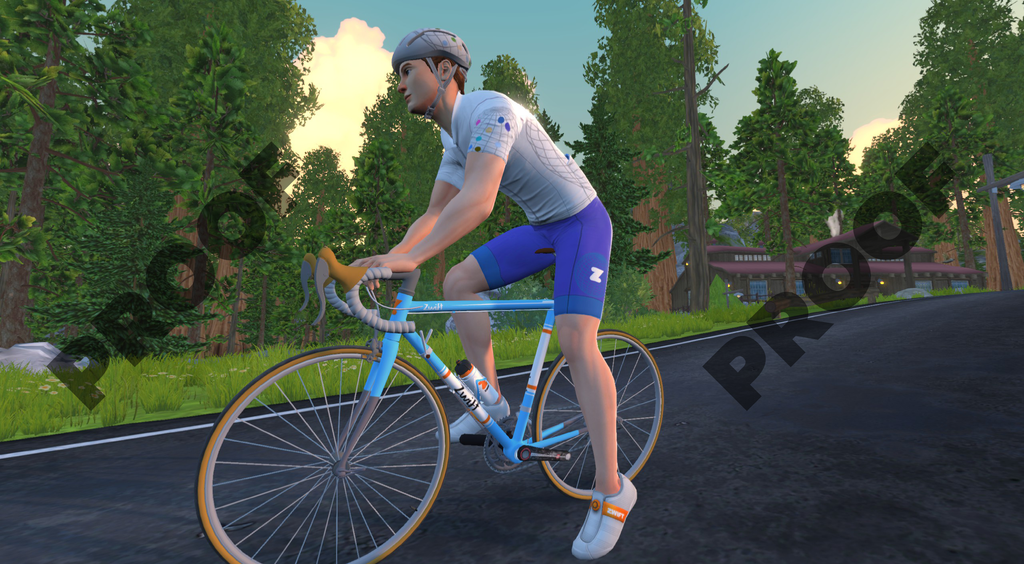 A cyclist in a white jersey and blue shorts rides a light blue road bike on a paved forest road.